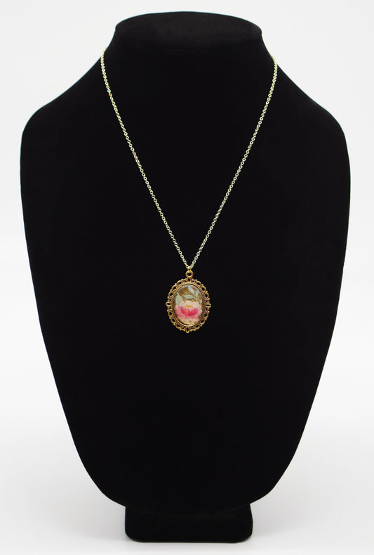 Pink rose mica resin necklace in gold-tone oval filigree frame on gold chain displayed on black jewelry bust