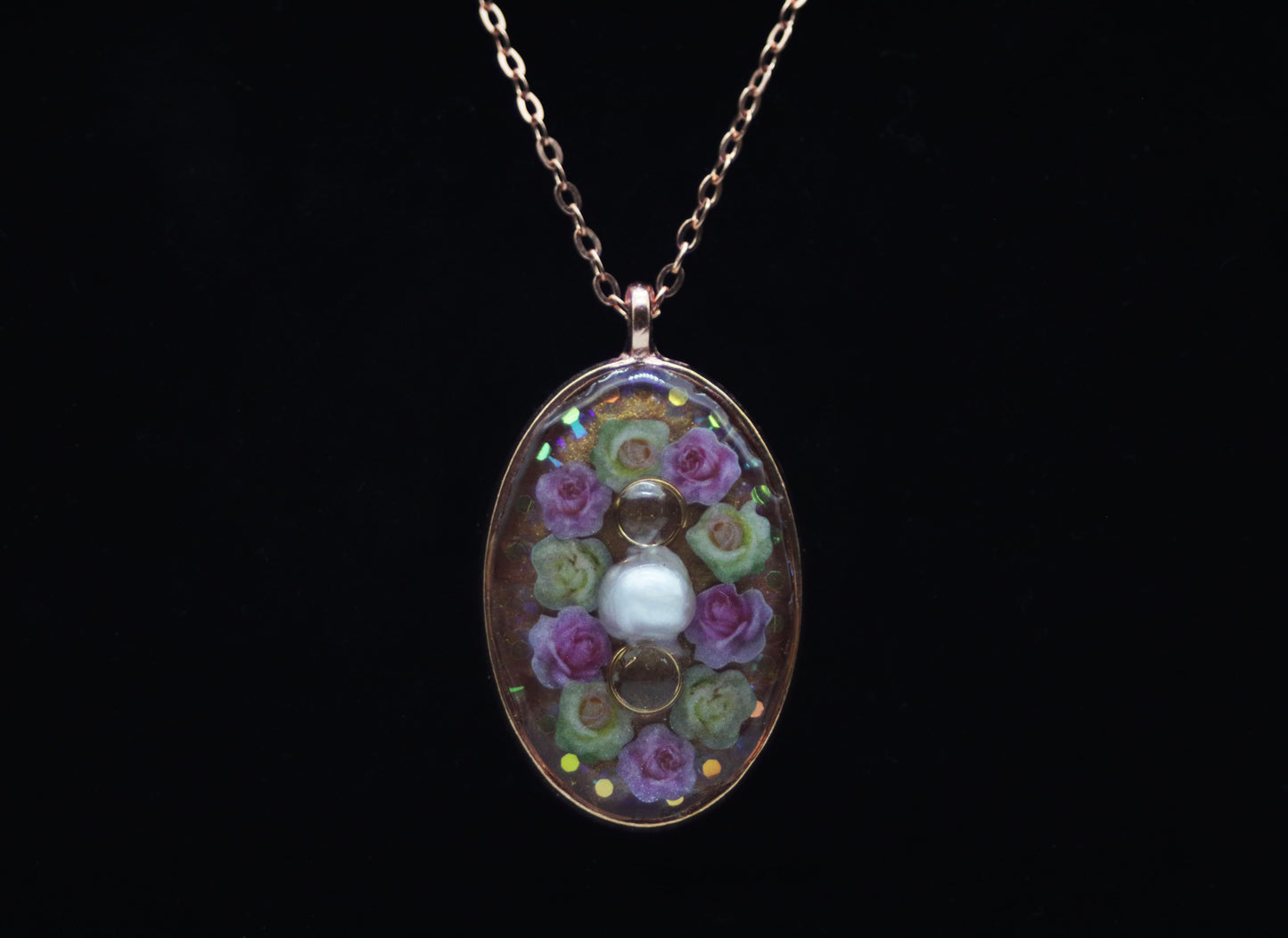 Rose gold oval resin necklace with pink and white wood flower roses and white pearl center accent