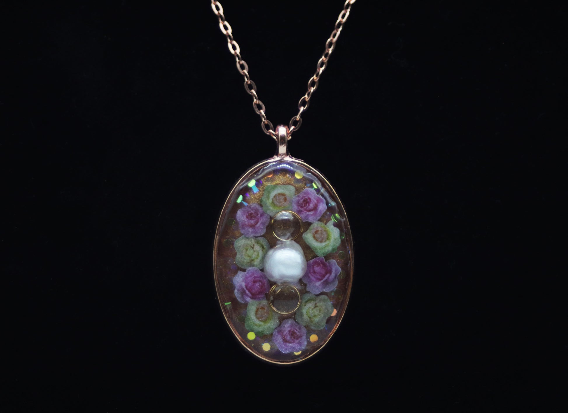 Rose gold oval resin necklace with pink and white wood flower roses and white pearl center accent