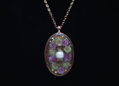 Rose gold oval resin necklace with pink and white wood flower roses and white pearl center accent