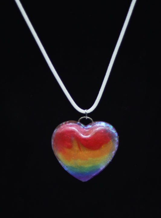 Chunky rainbow resin heart pendant necklace with iridescent shimmer on white cord