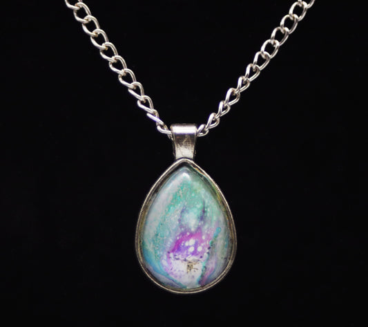 Silver teardrop necklace with glass cabochon over teal purple lavender white swirl paint skin